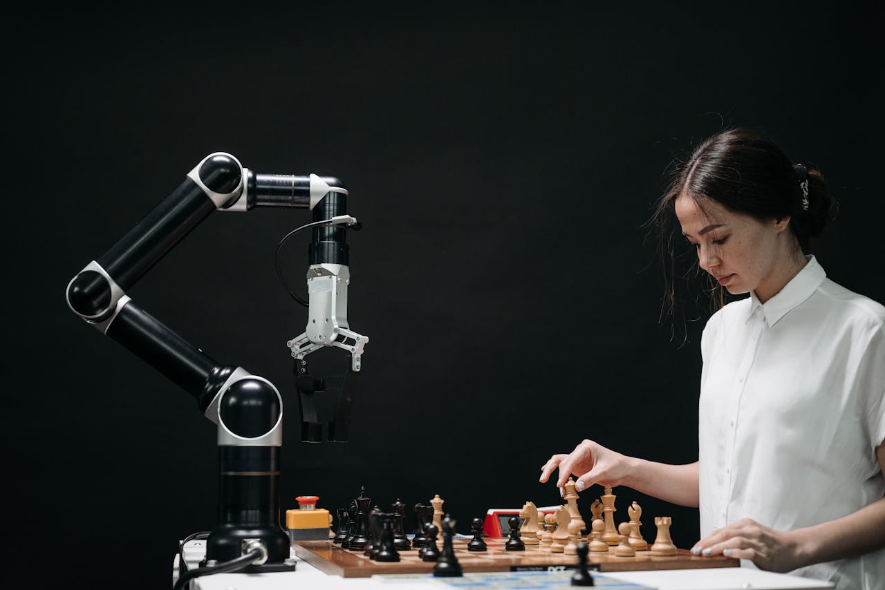 services-04 A woman plays chess against a robotic arm, showcasing AI innovation in a modern setting.